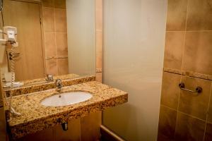 a bathroom with a sink and a mirror at Hotel Gergana - Ultra All Inclusive in Albena