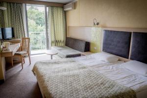 a hotel room with a large bed and a window at Hotel Gergana - Ultra All Inclusive in Albena +37 photos