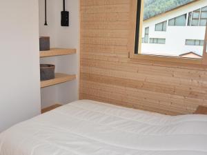 a bed in a room with a window at Chalet Pralognan-la-Vanoise, 4 pièces, 8 personnes - FR-1-464-188 in Pralognan-la-Vanoise