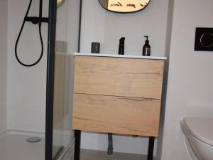 a bathroom with a wooden dresser with two bottles on it at Chalet Pralognan-la-Vanoise, 4 pièces, 8 personnes - FR-1-464-188 in Pralognan-la-Vanoise