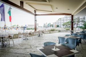 a restaurant with tables and chairs in front of the beach at Hotel Gergana - Ultra All Inclusive in Albena