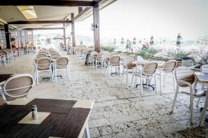 a row of chairs and tables in a restaurant at Hotel Gergana - Ultra All Inclusive in Albena