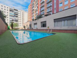 a swimming pool in the middle of a building at Stay U-nique Apartments Venecuela in Barcelona