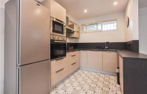 a kitchen with a stainless steel refrigerator and a sink at Amazing Apartment In Cannes With Wifi in Cannes