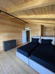 ein Schlafzimmer mit einem Bett in einem Holzzimmer in der Unterkunft Posh villa 2 in Kavajë
