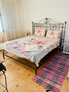 a bedroom with a bed with a metal frame and a rug at Marina Dinevi Complex Monastery 1 Saint Vlas in Sveti Vlas