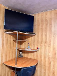 uma televisão numa parede com uma mesa e uma cadeira em Pid Yavorom em Ivano-Frankivsʼk