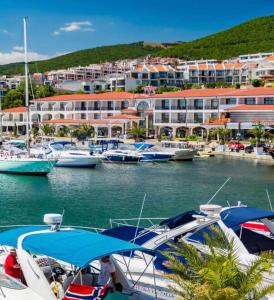 a group of boats docked in a marina with buildings at Marina Dinevi Complex Monastery 1 Saint Vlas in Sveti Vlas