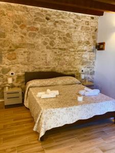 a bedroom with a bed with two towels on it at La Fattoria dei Sibillini in Montemonaco