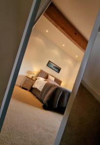 a mirror reflection of a bedroom with a bed at Lake View Lodge in Saint Columb Major