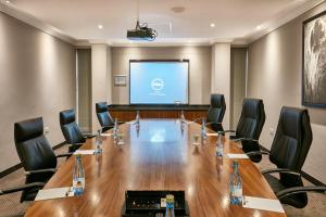 a conference room with a large table and chairs at Manong Game Lodge in Gaborone