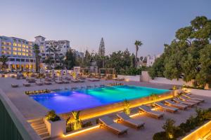 an overhead view of a pool with lounge chairs and a resort at Royal Azur Thalassa in Hammamet