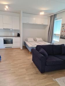 a living room with a couch and a bed at MR Apartments 2 in Vaasa