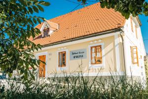 a house with a sign on the side of it at Štekner house Apartma in Ljubno