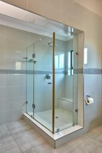 a glass shower stall in a bathroom at Regent Kgale Lodge in Gaborone