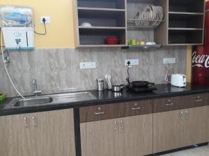 a kitchen with a sink and a counter top at City Central Hostel in Kolkata