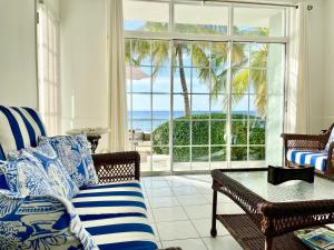 a living room with a couch and a view of the ocean at Sunset Cove - Vacation In Paradise! in Nassau