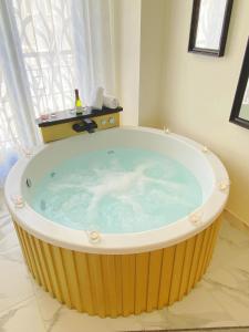 a jacuzzi tub in a bathroom with a window at Reina Victoria La Plaza in Alicante