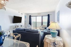 a living room with a couch and a table with a lamp at Plaza 1610 in Ocean City