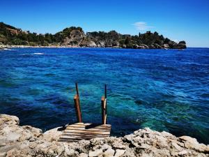 a dock in the middle of a body of water at Villa Isola Bella in Taormina