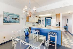 a dining room and kitchen with a glass table and chairs at Plaza 1610 in Ocean City