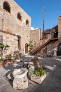 un edificio de piedra con un aseo delante en S.Nikolis' Historic Boutique Hotel en Rodas