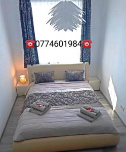 a bedroom with a bed with blue curtains and a window at Highsky Oradea Apartments in Oradea