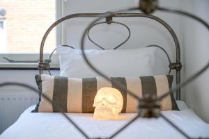 a skull on a pillow on a bed at Hello I'm Local - Boutique Hostel in Haarlem