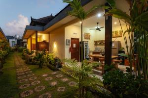a house with a garden in front of it at BUBU CANGGU Guesthouse in Canggu