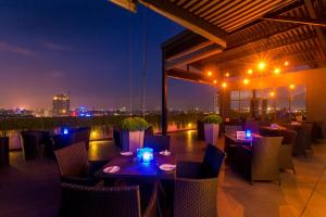 a restaurant with tables and chairs at night at Best Western Elyon Colombo in Colombo