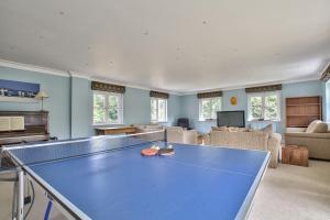 a living room with a ping pong table in it at Wellbrook Place by Group Retreats in Heathfield