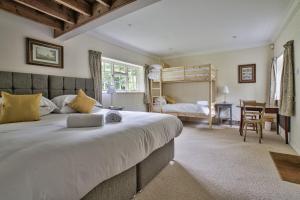 a bedroom with a large bed and a desk at Wellbrook Place by Group Retreats in Heathfield