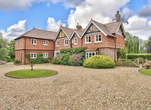 a large brick house with a gravel driveway at Wellbrook Place by Group Retreats in Heathfield