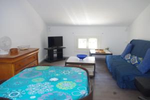 a living room with a blue couch and a table at Villa Nausicaa in Hyères