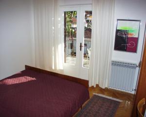 a bedroom with a bed next to a window at Rooms by the sea Jelsa, Hvar - 127 in Jelsa