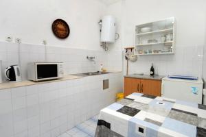 a kitchen with a sink and a microwave at Seaside holiday house Milna, Hvar - 114 in Hvar