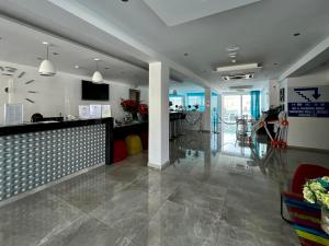 a lobby with a bar in the middle of a building at Sunny Blue Hotel in Ayia Napa