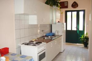 a white kitchen with a stove and a sink at Apartments by the sea Sucuraj, Hvar - 136 in Sućuraj