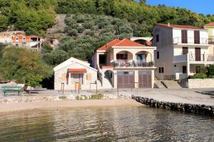a house on the shore of a body of water at Apartments by the sea Grscica, Korcula - 129 in Prizba