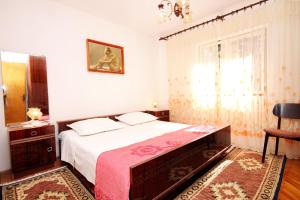 a bedroom with a large bed with a red blanket at Apartments by the sea Grscica, Korcula - 129 in Prizba