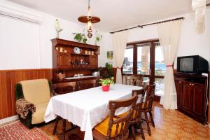 a dining room with a table and chairs at Apartments by the sea Grscica, Korcula - 129 in Prizba