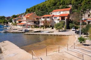 a group of houses next to a body of water at Apartments by the sea Grscica, Korcula - 129 in Prizba +12 photos