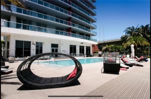 a swimming pool with a large building at Amazing Studio Apmt 2 Full Beds Amazing view 28B in Hallandale Beach