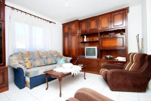 a living room with a couch and a tv at Apartments by the sea Brna, Korcula - 147 in Smokvica