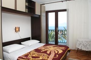 a bedroom with a bed and a view of the ocean at Apartment Sucuraj 136b in Sućuraj