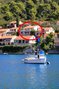 a boat in the water with a life ring on it at Apartment Brna 147a in Smokvica