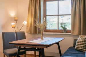 a table in a living room with a window at Ahrnhof in Innsbruck