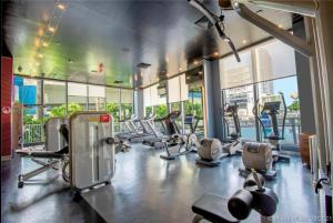 a gym with a bunch of treadmills and machines at Upscale Beach Apartment, Style, Views & Complete Kitchen -28A in Hallandale Beach
