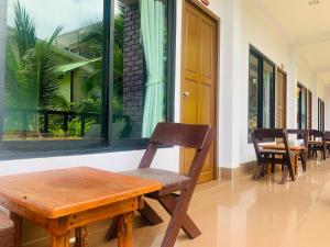 a wooden bench sitting in front of a window at View Garden Resort in Phi Phi Don