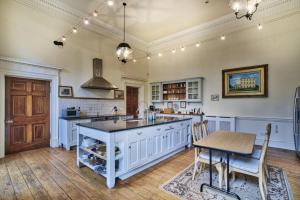 a kitchen with a large island and a table at The Castle By Group Retreats in Hartlepool